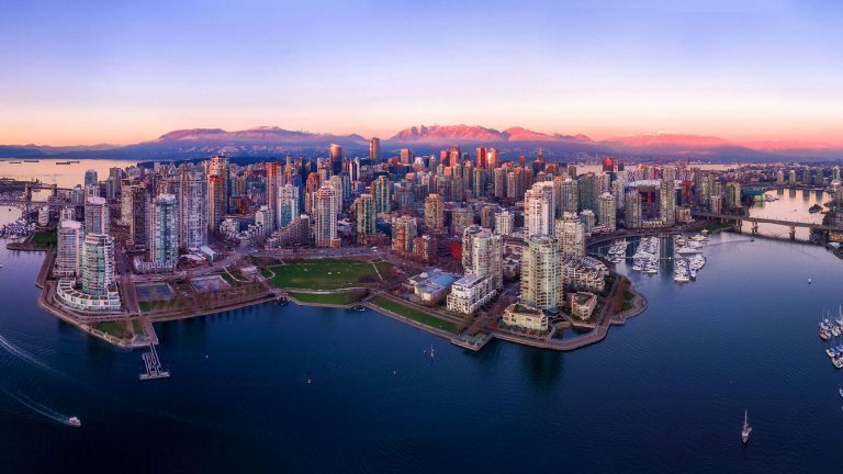 View of a cityscape next to a body of water.